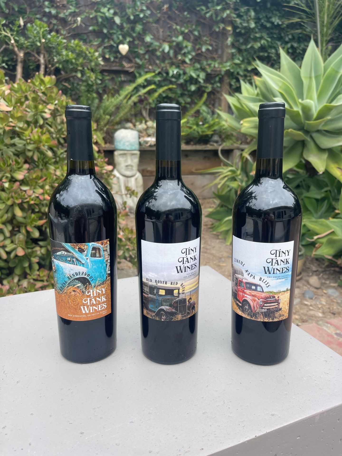 Two Tiny Tank wine bottles in warm light